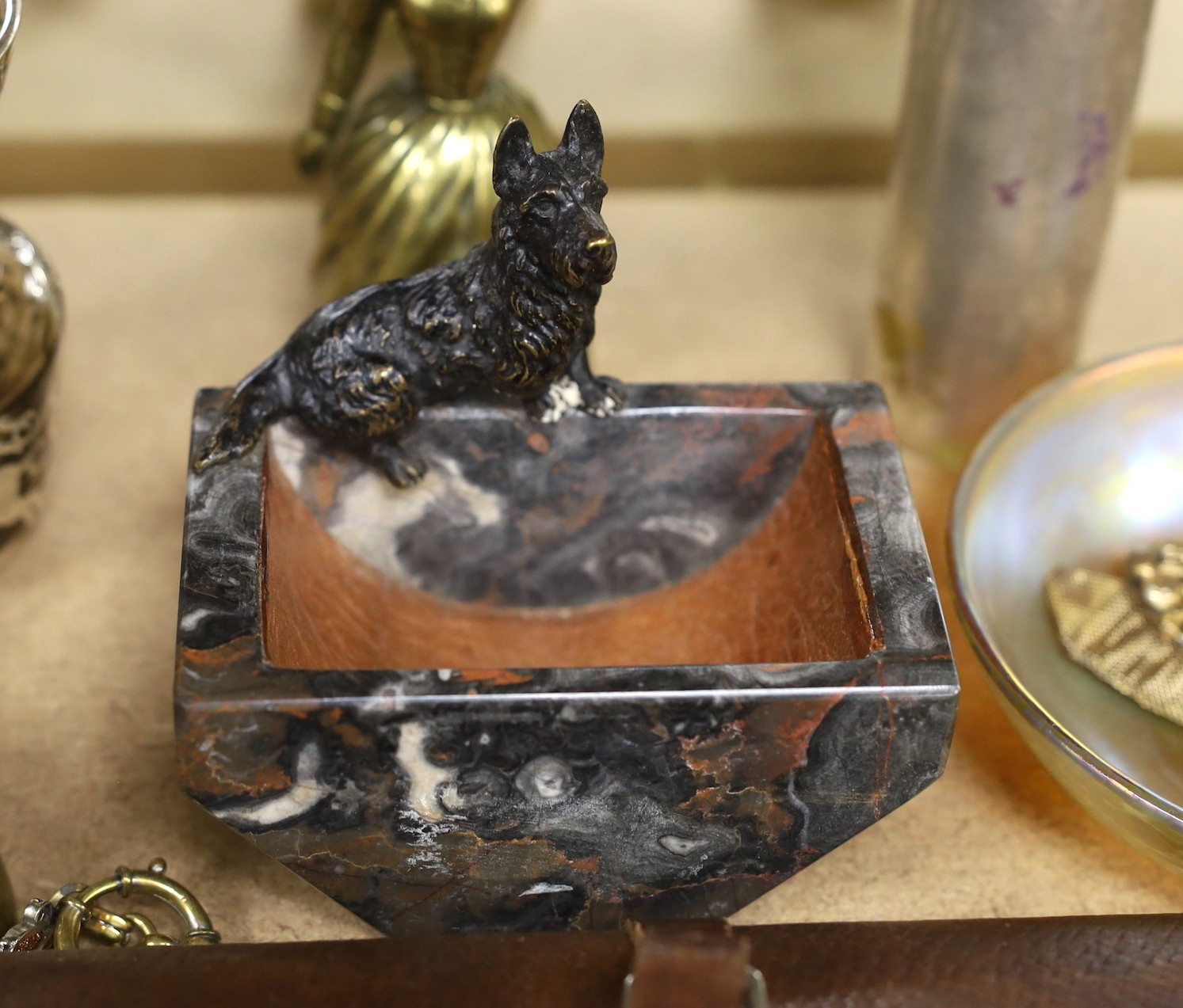 A quantity of various collectibles including a Hardys fishing wallet, a cold painted bronze ‘terrier’ mounted marble ash tray, bronze figural bell, pocket watches, Tiffany glass dish etc, dish11.5cms diameter